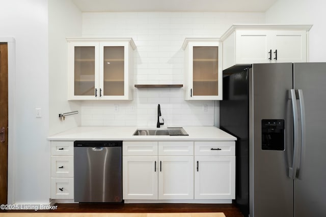 kitchen with light countertops, backsplash, appliances with stainless steel finishes, and a sink