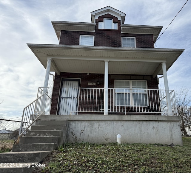 view of front facade featuring a porch and brick siding