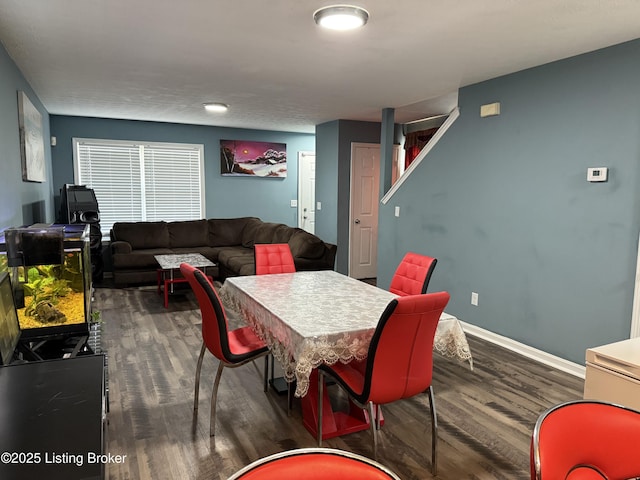 dining area featuring baseboards and wood finished floors