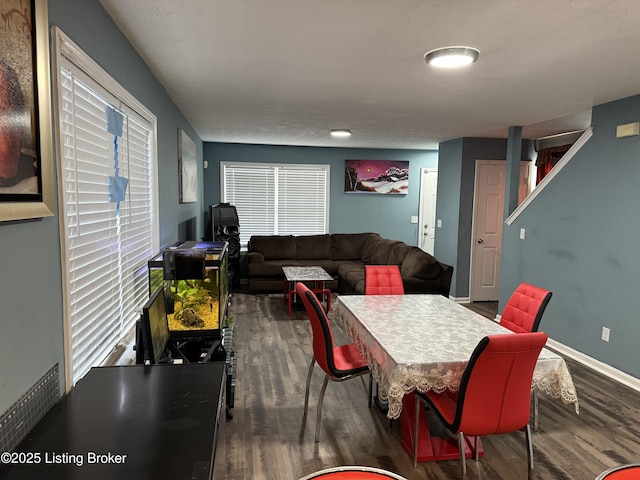 dining room featuring a wealth of natural light, baseboards, and wood finished floors