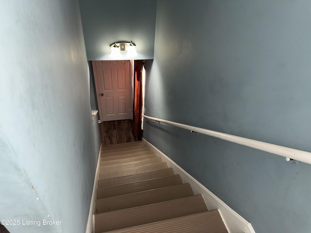 stairs featuring wood finished floors