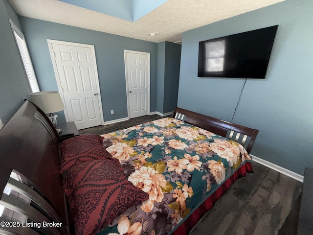 bedroom with wood finished floors and baseboards