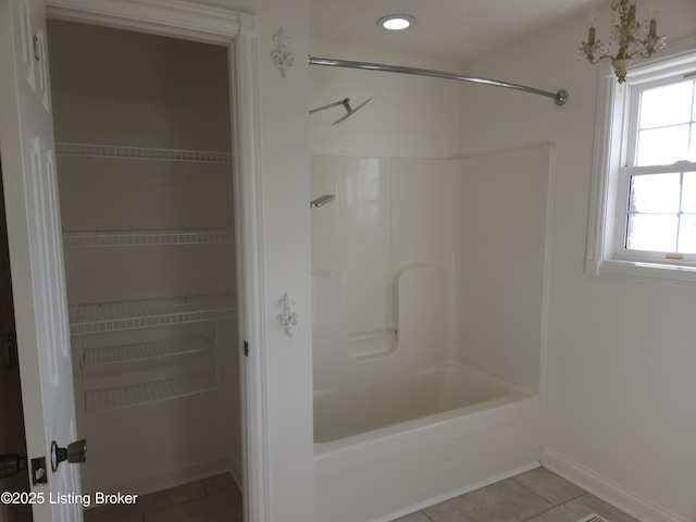 bathroom with tile patterned floors, bathing tub / shower combination, and recessed lighting