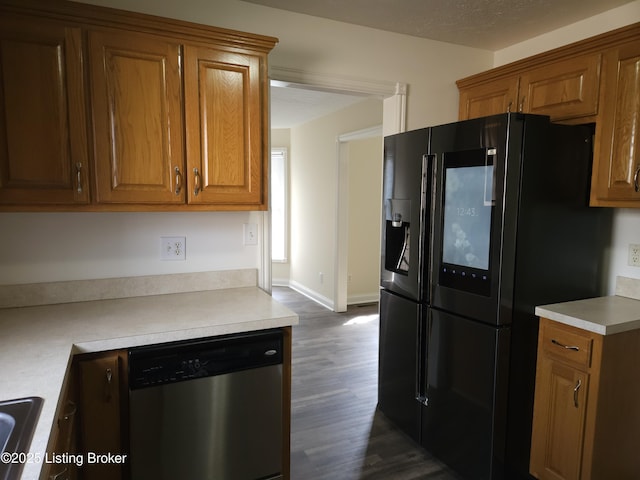 kitchen featuring light countertops, stainless steel dishwasher, brown cabinetry, black fridge with ice dispenser, and dark wood-style flooring