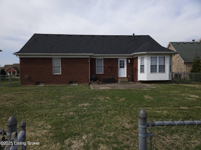 rear view of property featuring a shingled roof, fence, entry steps, a yard, and a patio area