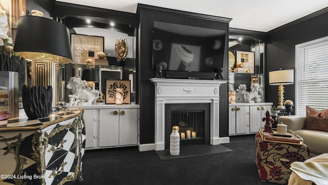 living area featuring a fireplace with flush hearth and ornamental molding