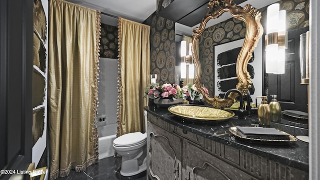 bathroom with wallpapered walls, toilet, double vanity, shower / bath combination with curtain, and a sink