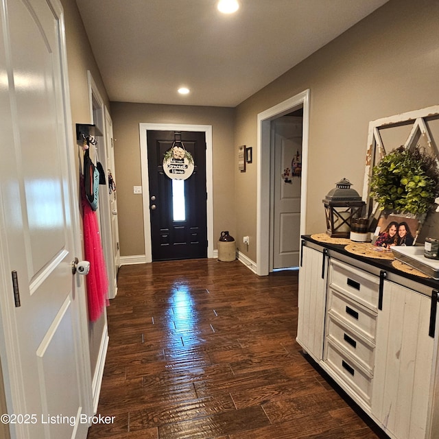 entrance foyer featuring recessed lighting, baseboards, and dark wood-type flooring