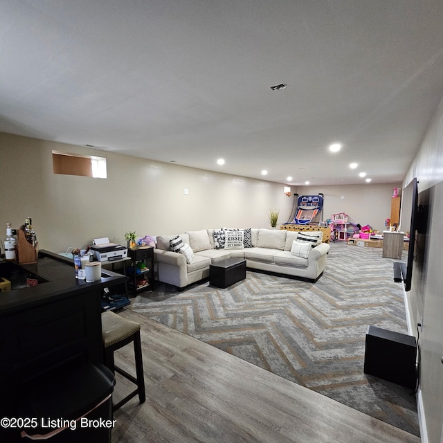 living area featuring recessed lighting and visible vents