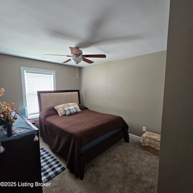 bedroom with baseboards, carpet floors, and a ceiling fan