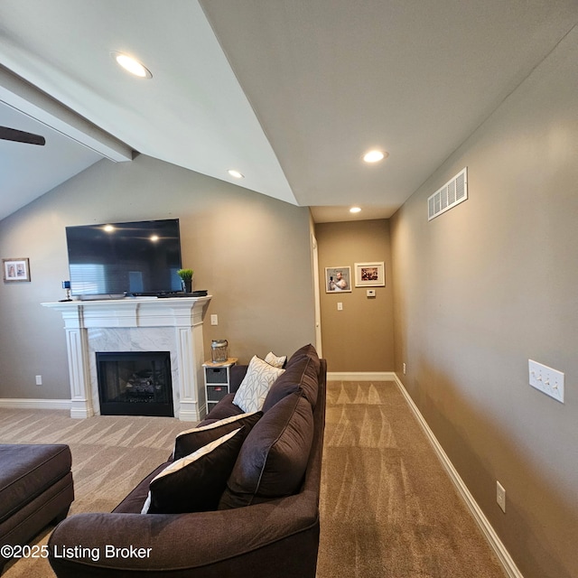 living area with visible vents, baseboards, and carpet