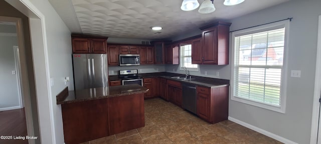 kitchen featuring a sink, visible vents, baseboards, and stainless steel appliances