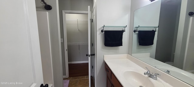 bathroom featuring vanity and a walk in closet