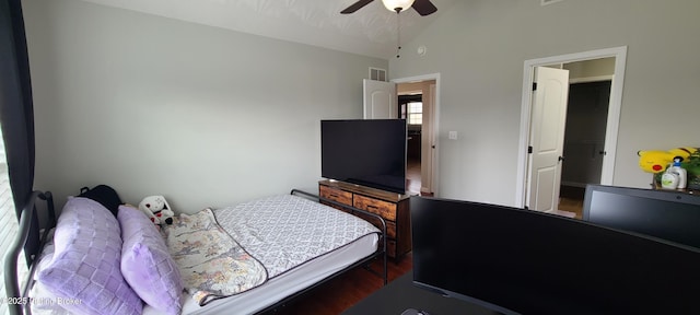 bedroom featuring lofted ceiling, wood finished floors, visible vents, and ceiling fan