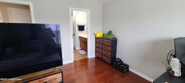 interior space featuring baseboards and dark wood finished floors