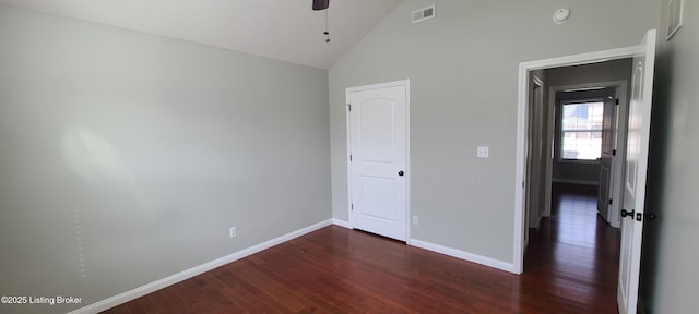 unfurnished bedroom featuring visible vents, high vaulted ceiling, wood finished floors, baseboards, and ceiling fan