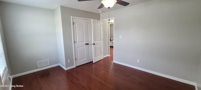 unfurnished bedroom with visible vents, ceiling fan, baseboards, wood finished floors, and a closet