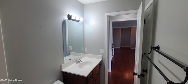 half bathroom featuring vanity and wood finished floors