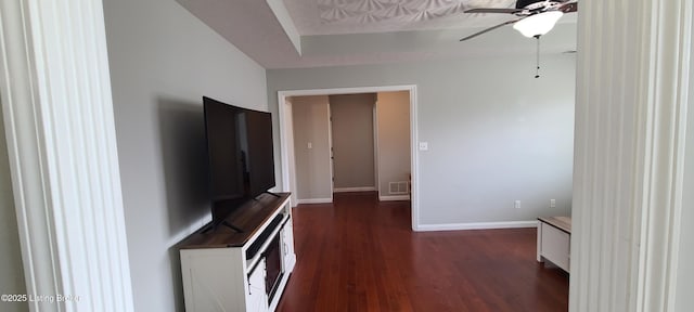 interior space with dark wood-type flooring, baseboards, and visible vents