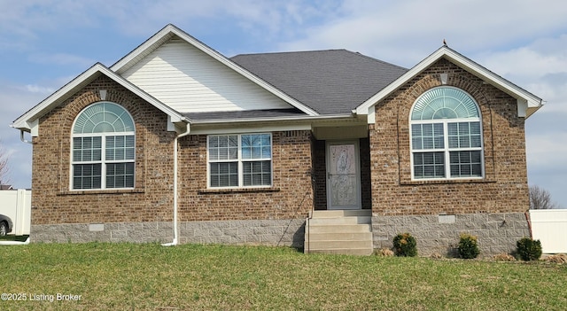 ranch-style home featuring a shingled roof, entry steps, a front lawn, crawl space, and brick siding