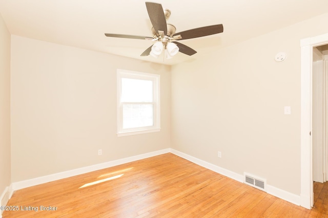 spare room with baseboards, visible vents, light wood finished floors, and ceiling fan