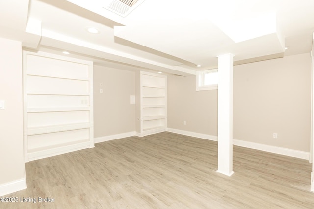 below grade area featuring recessed lighting, visible vents, light wood-style flooring, and baseboards