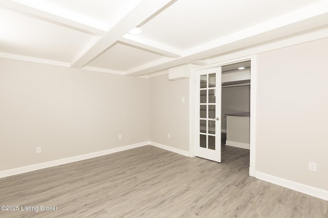 unfurnished room with baseboards, coffered ceiling, beam ceiling, and wood finished floors