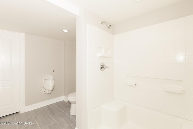 bathroom featuring baseboards, toilet, and walk in shower