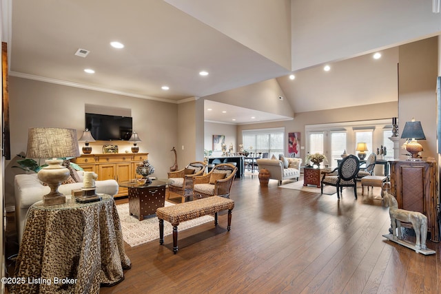 living room with visible vents, ornamental molding, recessed lighting, a towering ceiling, and wood-type flooring