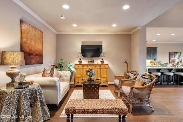 living room with baseboards, recessed lighting, dark wood-style flooring, and ornamental molding