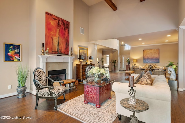 living room with visible vents, baseboards, a fireplace, and dark wood-style flooring