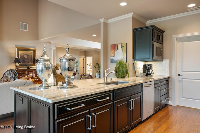 kitchen featuring dark wood-type flooring, crown molding, a peninsula, and visible vents