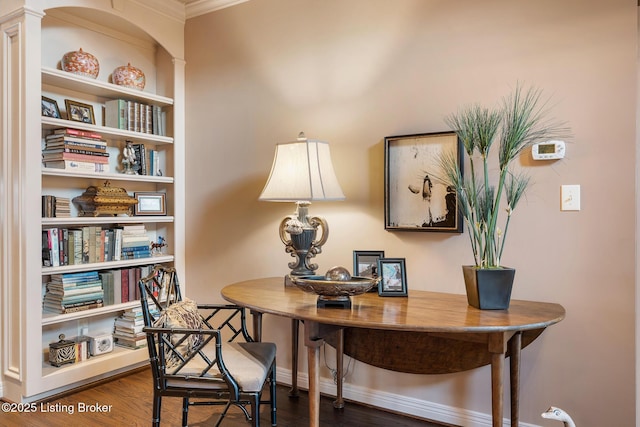 home office with baseboards and wood finished floors