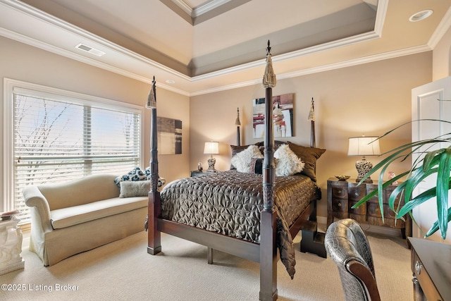 bedroom with a tray ceiling, carpet flooring, crown molding, and visible vents