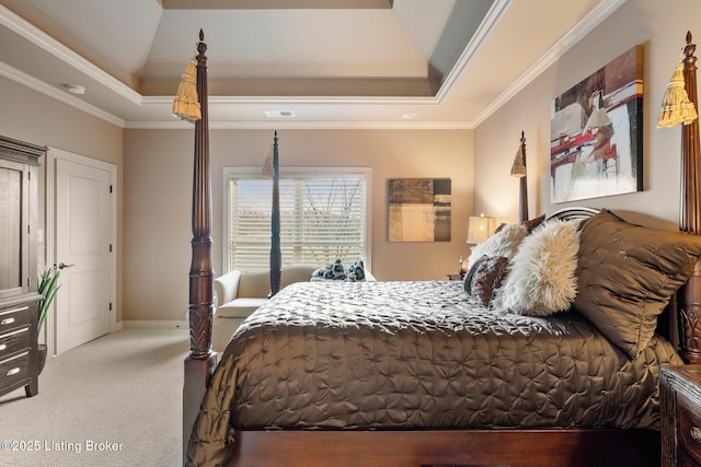 carpeted bedroom with a raised ceiling, baseboards, visible vents, and ornamental molding