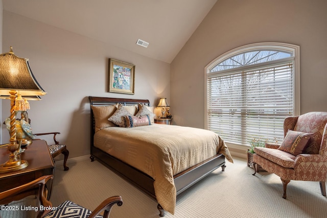 carpeted bedroom with vaulted ceiling, baseboards, and visible vents