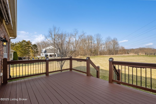 wooden terrace featuring a yard