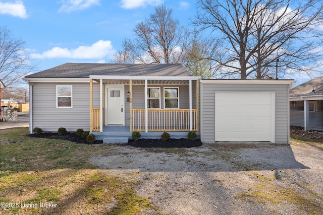 view of front of home featuring a garage, gravel driveway, roof with shingles, and a porch