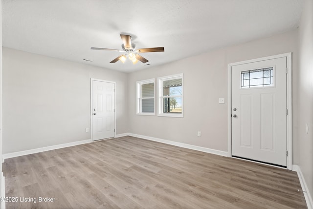 entrance foyer featuring a healthy amount of sunlight, light wood-style flooring, and baseboards