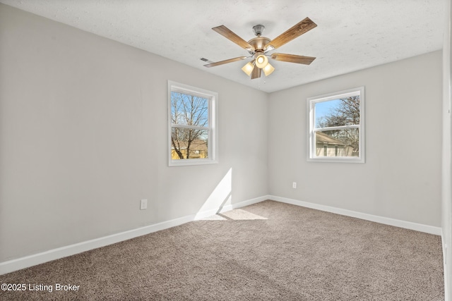 spare room with baseboards, carpet, and a healthy amount of sunlight