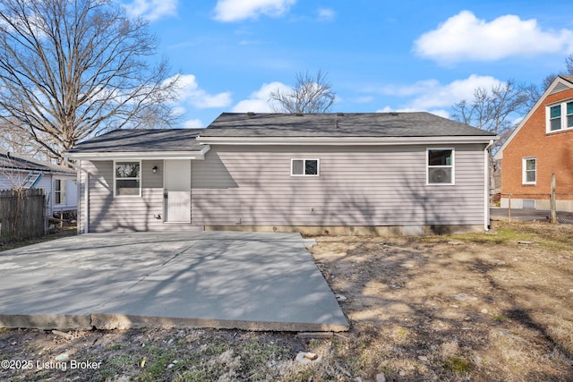 rear view of property featuring a patio and fence