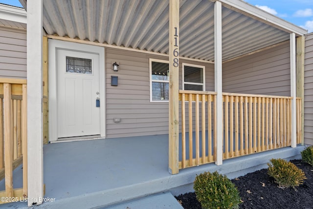 view of exterior entry with covered porch