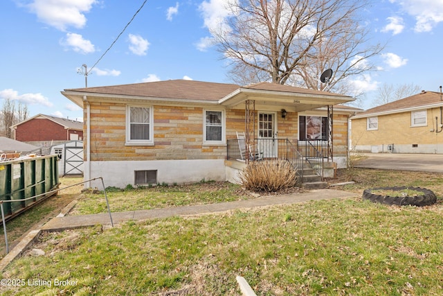 view of front of house with a porch, fence, and a front lawn