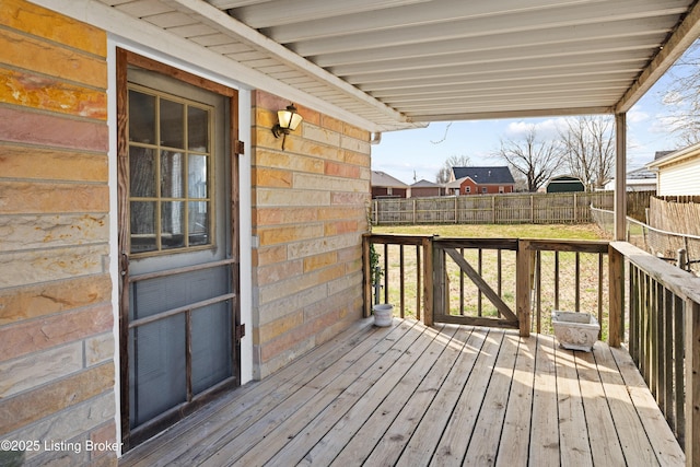 wooden terrace with fence and a lawn