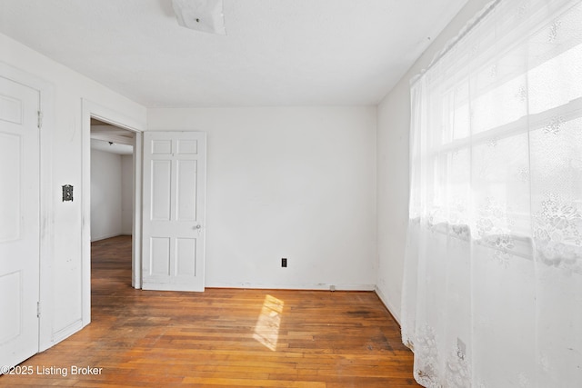 spare room with wood-type flooring