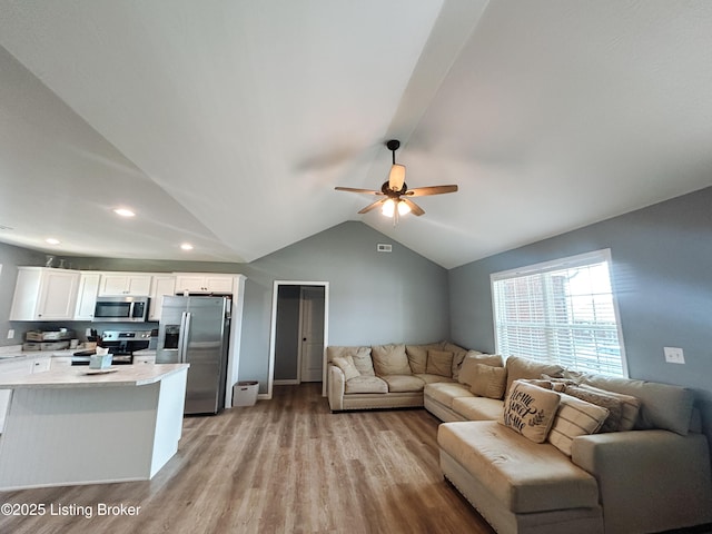 living room with visible vents, light wood finished floors, recessed lighting, ceiling fan, and vaulted ceiling