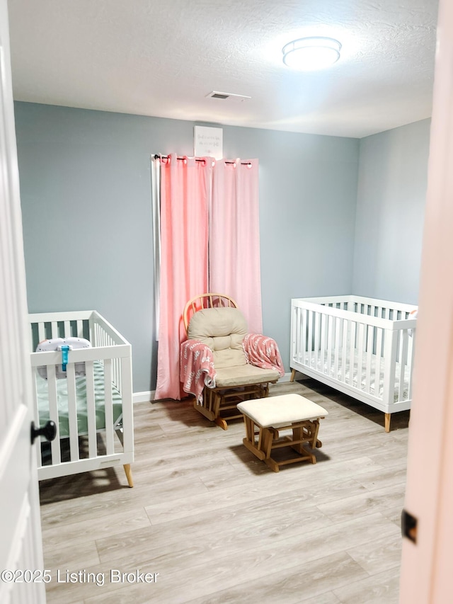 306 Oak Hill Ct, Bardstown, KY 40004 - bedroom featuring wood finished floors, visible vents, and a textured ceiling