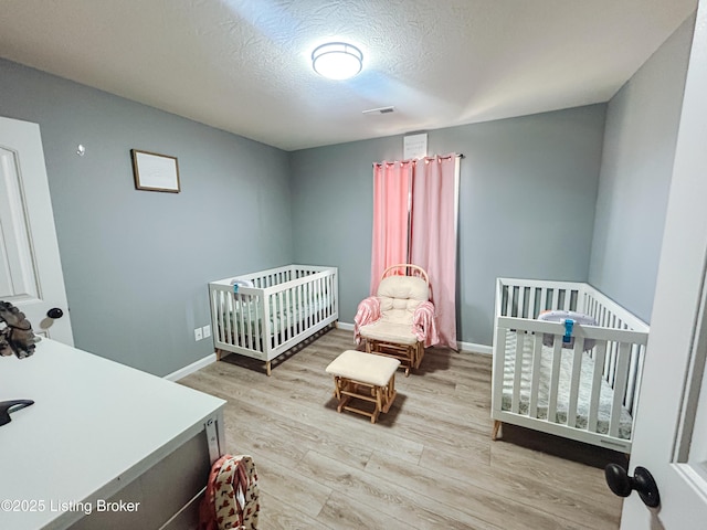 306 Oak Hill Ct, Bardstown, KY 40004 - bedroom featuring visible vents, a textured ceiling, baseboards, and wood finished floors