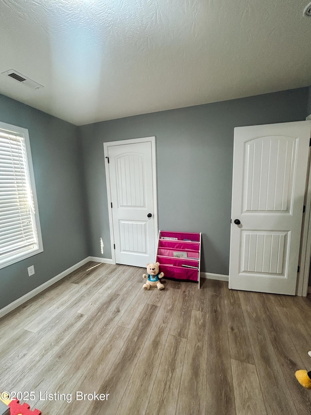 306 Oak Hill Ct, Bardstown, KY 40004 - bedroom with visible vents, baseboards, a textured ceiling, and wood finished floors