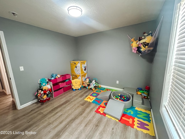 306 Oak Hill Ct, Bardstown, KY 40004 - playroom featuring wood finished floors, baseboards, and a textured ceiling